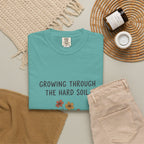 Grace in Progress Faith T-Shirt — Growing Through the Hard Soil — Vintage Terracotta Plant Christian Tee | Healing & Growth Design for Women